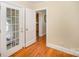 Hallway with hardwood floors leading to the kitchen and an exit door with windows at 2125 Chatham Ave, Charlotte, NC 28205