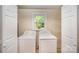 Bright laundry area with convenient washer and dryer connections and a window for ventilation at 2125 Chatham Ave, Charlotte, NC 28205