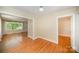Cozy living room with hardwood floors, fireplace and large windows that bring in natural light at 2125 Chatham Ave, Charlotte, NC 28205