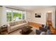 Bright living room with hardwood floors, large windows, and neutral-toned furnishings, creating a welcoming atmosphere at 2125 Chatham Ave, Charlotte, NC 28205