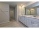 Modern bathroom with double vanity, quartz countertop, and bright tile flooring, a luxurious retreat at 2127 Rolling Hills Ct, Stanley, NC 28164