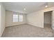 Spacious bedroom with neutral walls, plush carpet, and natural light from two bright windows at 2127 Rolling Hills Ct, Stanley, NC 28164