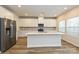 Modern kitchen featuring white cabinets, stainless steel appliances and a large center island at 2127 Rolling Hills Ct, Stanley, NC 28164