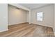 Bright living room featuring wood-look floors, neutral paint, and a view of the yard at 2127 Rolling Hills Ct, Stanley, NC 28164