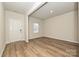 Inviting living room featuring wood-look floors, and a bright window at 2127 Rolling Hills Ct, Stanley, NC 28164