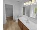 Bright bathroom with a vanity, mirror, tiled floors, and a view into an adjoining closet at 2140 Majestic Poplar Dr, Waxhaw, NC 28173