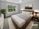 Bright and airy bedroom with a large window, plush bedding, and stylish decor at 2140 Majestic Poplar Dr, Waxhaw, NC 28173