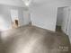 Open bedroom with neutral walls, soft carpeting, and multiple entryways to connected rooms at 2140 Majestic Poplar Dr, Waxhaw, NC 28173
