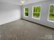 Bright bedroom boasts large windows offering views of the lush greenery outside at 2140 Majestic Poplar Dr, Waxhaw, NC 28173