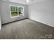 Spacious bedroom featuring a large window and plush carpeting, providing a comfortable retreat at 2140 Majestic Poplar Dr, Waxhaw, NC 28173
