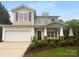 Charming two-story home featuring a covered front porch, attached garage and well-maintained landscaping at 2140 Majestic Poplar Dr, Waxhaw, NC 28173