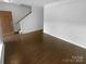 Open-concept living room with hardwood floors, offering a versatile space for relaxation and entertainment at 2140 Majestic Poplar Dr, Waxhaw, NC 28173