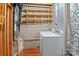 Unfinished basement with laundry area and built-in wooden storage racks offers a utilitarian space at 218 Water Oak Dr, Pineville, NC 28134