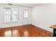 Light-filled bedroom with hardwood floors, a window, and a door to the outside at 218 Water Oak Dr, Pineville, NC 28134