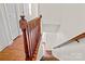Hardwood stairway with wooden railing leads to the next floor in this bright and modern home at 218 Water Oak Dr, Pineville, NC 28134
