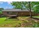 Backyard with brick house, deck, green grass and mulch providing a relaxing outdoor space at 2202 Bearskin Ln, Monroe, NC 28110