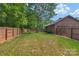 Spacious backyard with privacy fence, mature trees, and well-manicured lawn at 2202 Bearskin Ln, Monroe, NC 28110