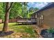 Backyard with brick house, deck, green grass, mulch and wooded fence providing a private outdoor space at 2202 Bearskin Ln, Monroe, NC 28110