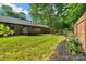 Backyard with brick house, deck, green grass, mulch and flower providing a peaceful outdoor space at 2202 Bearskin Ln, Monroe, NC 28110