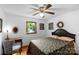 Comfortable bedroom with a ceiling fan, window, and desk, offering a relaxing and functional space at 2202 Bearskin Ln, Monroe, NC 28110