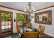 Charming dining area features an ornate mirror, chandelier, and door to the deck to enjoy natural light at 2202 Bearskin Ln, Monroe, NC 28110