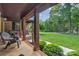 Cozy covered porch with comfortable seating and views of a beautifully landscaped front yard at 2202 Bearskin Ln, Monroe, NC 28110