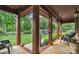 Covered front porch featuring natural wood support columns, comfortable seating, and a peaceful outdoor ambiance at 2202 Bearskin Ln, Monroe, NC 28110