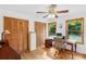 Bright home office with hardwood floors, wood cabinets and plenty of natural light through large windows at 2202 Bearskin Ln, Monroe, NC 28110