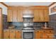 Classic kitchen featuring wooden cabinetry, sleek countertops, and stainless steel appliances at 2202 Bearskin Ln, Monroe, NC 28110