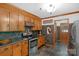 Traditional kitchen with wooden cabinets, stainless steel appliances, and adjacent doorway at 2202 Bearskin Ln, Monroe, NC 28110