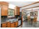 Well-lit kitchen with stainless steel appliances and a sink overlooking the serene greenery of the backyard at 2202 Bearskin Ln, Monroe, NC 28110