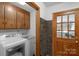 Laundry area showcasing a modern washer and dryer alongside access to the exterior at 2202 Bearskin Ln, Monroe, NC 28110