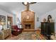 Cozy living room with brick fireplace, wood beam and a ceiling fan creating a warm and inviting atmosphere at 2202 Bearskin Ln, Monroe, NC 28110