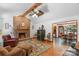 Inviting living room with fireplace, wood beams, opening to dining area, creating an easy flow for gatherings at 2202 Bearskin Ln, Monroe, NC 28110
