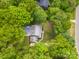 Aerial view of home featuring mature trees, a deck with hot tub, and established landscaping at 2329 Wedgewood Dr, Matthews, NC 28104