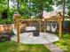 Backyard with a pergola and hammocks over a round stone surface, perfect for relaxing at 2329 Wedgewood Dr, Matthews, NC 28104