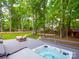 Large backyard featuring a deck with a hot tub, lounging area, and space for entertainment and activities at 2329 Wedgewood Dr, Matthews, NC 28104