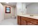 The bathroom has a single sink with wooden cabinets, a window, a mirror, and a toilet at 2329 Wedgewood Dr, Matthews, NC 28104