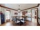 Cozy dining room featuring hardwood floors, wood trim, stylish light fixture, and seating for four at 2329 Wedgewood Dr, Matthews, NC 28104