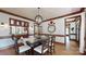 Elegant dining area with stylish light fixture, wood trim, and seamless access to the kitchen at 2329 Wedgewood Dr, Matthews, NC 28104