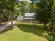 Traditional two-story home with a charming front porch, well-manicured lawn, and mature trees at 2329 Wedgewood Dr, Matthews, NC 28104