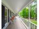 Inviting front porch with white railings, rocking chairs, and views of the lush, mature landscape at 2329 Wedgewood Dr, Matthews, NC 28104