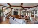 Spacious living room with hardwood floors, wood accents, and a large TV screen at 2329 Wedgewood Dr, Matthews, NC 28104