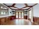 Living room featuring wood floors, coffered ceiling, wood trim, and backyard access at 2329 Wedgewood Dr, Matthews, NC 28104