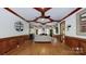 Spacious living room featuring wood floors, coffered ceiling, fireplace, and ample natural light at 2329 Wedgewood Dr, Matthews, NC 28104