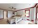 This is a bright, well-lit main bedroom with white trim, a ceiling fan, and a bench at the foot of the bed at 2329 Wedgewood Dr, Matthews, NC 28104