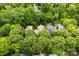 An aerial view shows a neighborhood surrounded by lush green trees at 2311 Club Rd, Charlotte, NC 28205