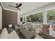 Cozy back porch with wicker furniture, ceiling fan, and a pleasant view of the neighborhood at 2311 Club Rd, Charlotte, NC 28205