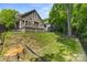Spacious backyard featuring a deck and mature trees providing shade and privacy at 2311 Club Rd, Charlotte, NC 28205