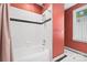 Bathroom features a soaking tub with shower, tile surround, and classic tile flooring at 2311 Club Rd, Charlotte, NC 28205